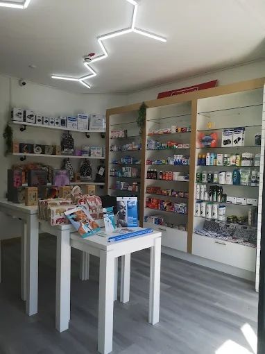 Inside Oxshott Village Pharmacy, shelves of health products and a gift table